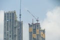 Inside place for many tall buildings under construction and cranes under a blue sky