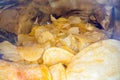 Inside the potato chips bag. Opened pack of original taste delicious potato crisps. Fast food and unhealthy eating concept