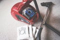 Inside A red vacum cleaner with old and new vacum filter bags laying on a white carpet floor.