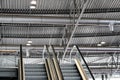 Inside roof of metal hall, elevators leading to second floor