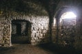 Inside of ruins of Chortkiv castle, Ukraine. Destroyed ruined brick walls and window light in dark indoors of medieval castle, Royalty Free Stock Photo