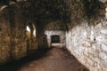 Inside of ruins of Chortkiv castle, Ukraine. Destroyed ruined brick walls and window light in dark indoors of medieval castle,