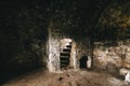 Inside of ruins of Chortkiv castle, Ukraine. Destroyed ruined brick walls and window light in dark indoors of medieval castle, Royalty Free Stock Photo