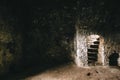 Inside of ruins of Chortkiv castle, Ukraine. Destroyed ruined brick walls and window light in dark indoors of medieval castle, Royalty Free Stock Photo