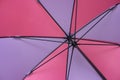 Inside shot of open colorful umbrella with black metal spoke and pole