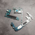 The inside of the smartphone's motherboard and tools lay on the back table. the concept of computer hardware, mobile Royalty Free Stock Photo