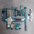 The inside of the smartphone's motherboard and tools lay on the back table. the concept of computer hardware, mobile Royalty Free Stock Photo