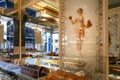 Inside the Stohrer Patisserie store with an old painting of a girl holding cakes in her hands