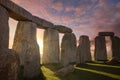 Inside the Stonehenge Circle of Stones with a Dramatic Sky Sunrise behind it Royalty Free Stock Photo