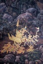 Inside a Thai temple, a traditional mural painting recounts a captivating battle scene,