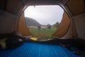 Inside the tourist tent, first person view. Foggy morning near the river. Folding chair and table. Tourism and hobby