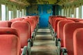 The inside of a train car is empty and mostly red Royalty Free Stock Photo