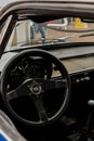 Inside view of an alpine car with a black steering wheel and interior