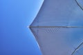 Inside view of a beach umbrella with blue sky in the background Royalty Free Stock Photo