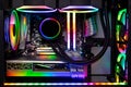 Inside view black high end custom colorful illuminated bright rainbow RGB LED gaming pc. Computer power hardware and technology