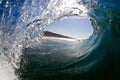 Inside view of a breaking wave on a tropical beach under a blue sky Royalty Free Stock Photo