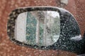 Inside view of car rearview mirror during rain, selective focus Royalty Free Stock Photo