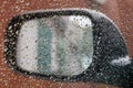 Inside view of car rearview mirror during rain, selective focus Royalty Free Stock Photo
