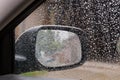 Inside view of car rearview mirror during rain, selective focus Royalty Free Stock Photo