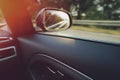 inside view on door panel and passenger side window of a fast moving modern upper-middle class car in bright leaking sunlight Royalty Free Stock Photo