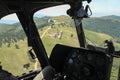 Inside view of a helicopter in flight, flying a helicopter over mountain forest Royalty Free Stock Photo