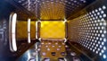 Inside view of a kitchen grater. Metal surface texture with holes Royalty Free Stock Photo