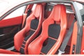 Inside view of a luxury red Ferrari 430 Scuderia sports car, with a modern red leather interior