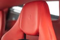 Inside view of a luxury red Ferrari 430 Scuderia sports car, with a modern red leather interior