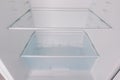 An Inside View of a Modern Refrigerator Showcasing Empty Glass Shelves and Compartment for Food Storage Royalty Free Stock Photo