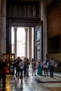 Inside view of people next to the big entrance door at the famous Pantheon building in Rome. Royalty Free Stock Photo