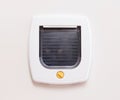 Inside view of a regular white cat flap, cat comming through Royalty Free Stock Photo