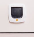 Inside view of a regular white cat flap, cat comming through Royalty Free Stock Photo