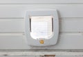 Inside view of a regular white cat flap, flap closed Royalty Free Stock Photo