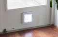 Inside view of a regular white cat flap, flap closed Royalty Free Stock Photo