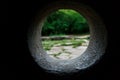 Inside view of a stone dolmen out through a hole in a mountain forest in the valley of the river Jean