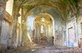 Inside view in sun light of abandoned catholic church XVIII century in Mezhyriv village in Ukraine