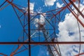 Inside view of telecommunication tower with microwave, radio panel antennas, outdoor remote radio units, power cables