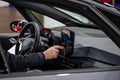 Inside view of the Volkswagen VW ID4 electric car, driver setting up satnav using touchscreen