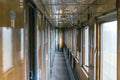 Inside of vintage train wagon. Corridor with wooden cabins. Royalty Free Stock Photo