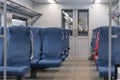 Inside The Wagon Train. Empty train interior. interior view of corridor inside passenger trains with blue fabric seats Royalty Free Stock Photo