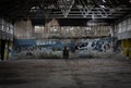 Inside wall of abandoned building with worn graffiti