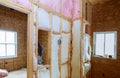 Inside wall heat isolation with mineral wool in wooden house, building under construction Royalty Free Stock Photo