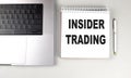 INSIDER TRADING text on notebook with laptop and pen Royalty Free Stock Photo