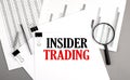 INSIDER TRADING text on paper on chart background Royalty Free Stock Photo