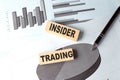 INSIDER TRADING wooden block on chart background Royalty Free Stock Photo
