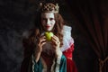 insidious medieval queen in red dress with green apple
