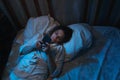 Insomnia, sleeplessness. Woman lying awake in bed at night.