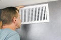 Inspecting a Home Air Vent for Maintenance Royalty Free Stock Photo