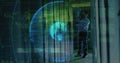 Inspecting tech in light shirt checking server racks in datacenter with hologram globe, copy space Royalty Free Stock Photo