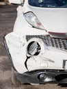 Inspection of the car after an accident on the road. The front fender and left headlight are broken, damaged and scratched on the